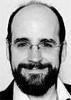 Freundlich lächelnder Mann mit Vollbart und Brille